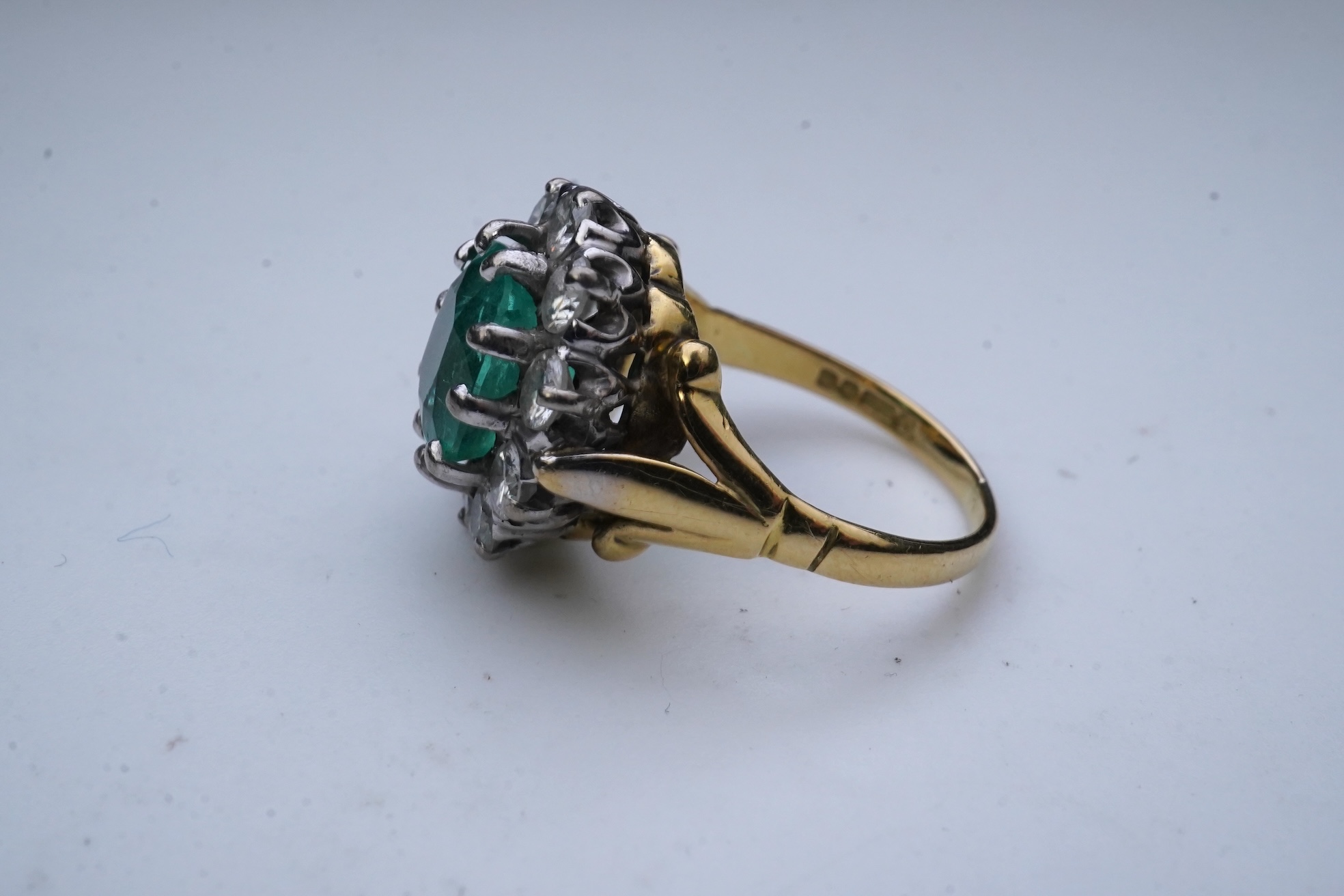 An emerald and diamond ring